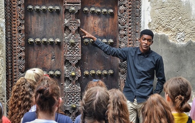 Tour guide explaining Stone Town history Zanzibar