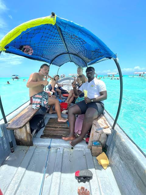 mnemba snorkling tourist with boat
